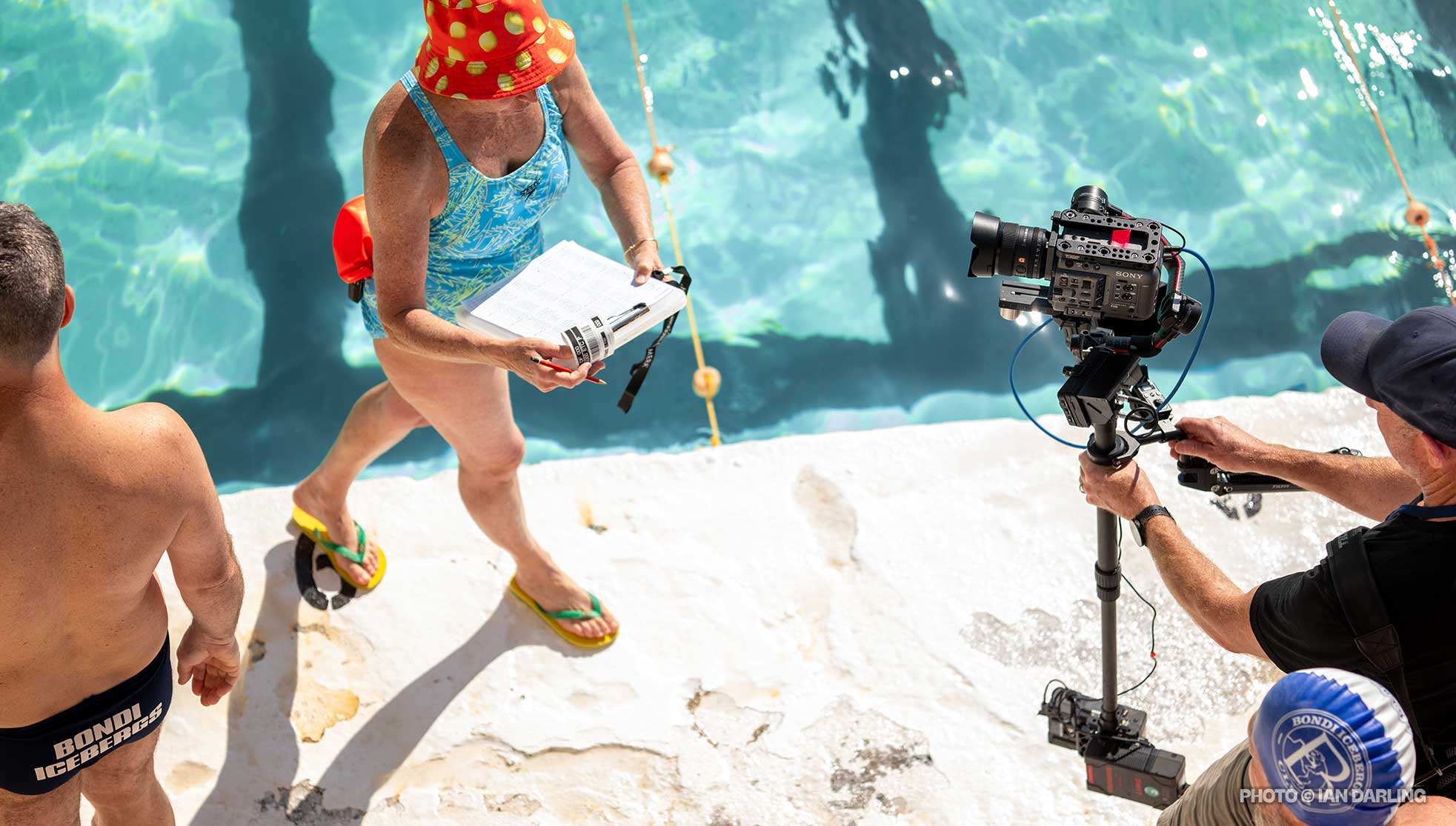 Filming a woman and clipboard, poolside