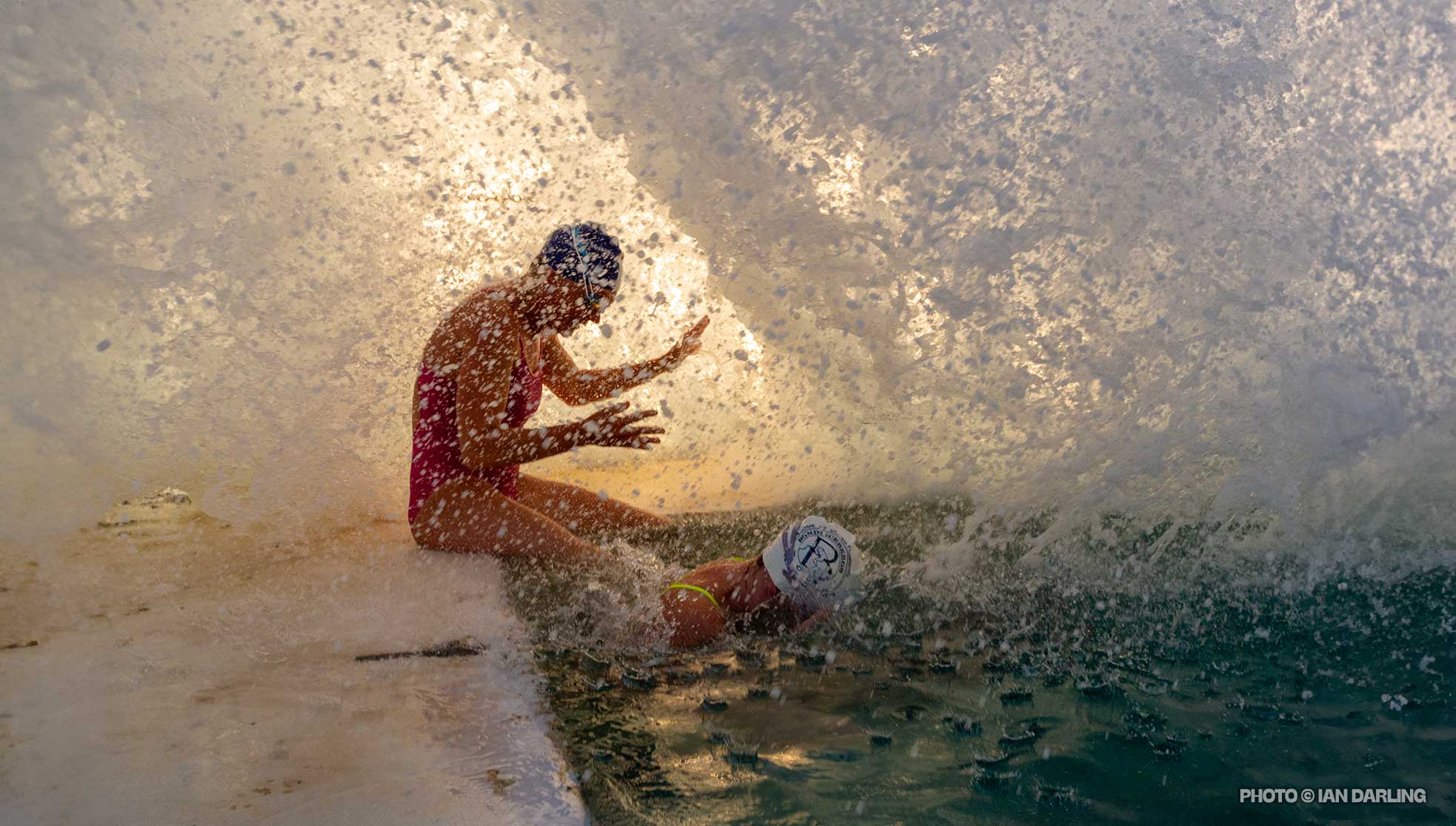 Huge splash covers 2 swimmers